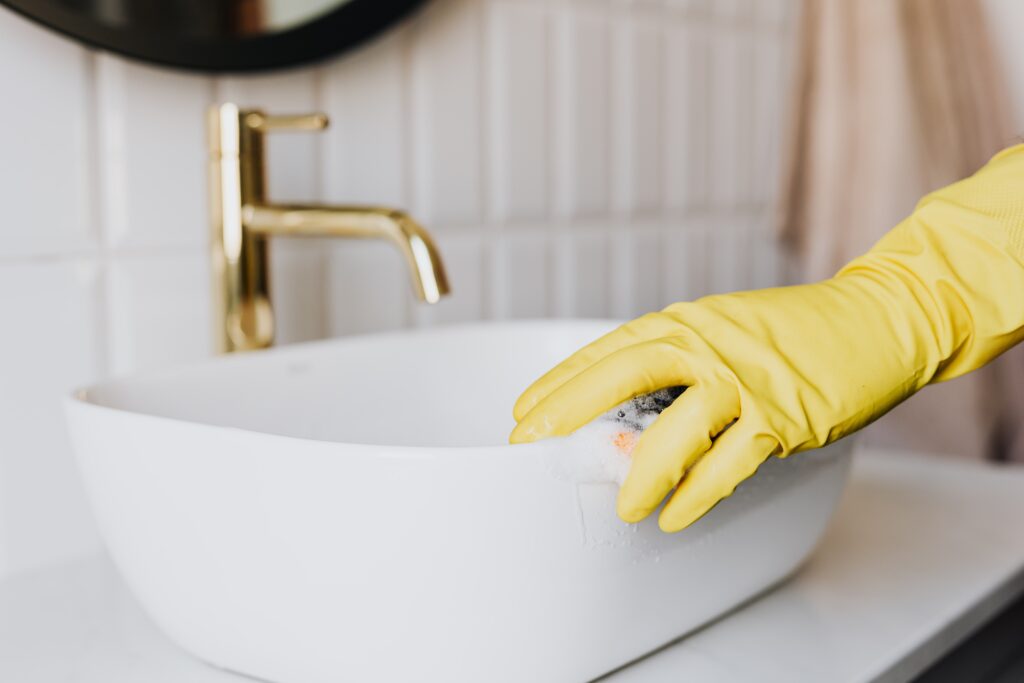 Close up shot of a bathroom sink being cleaned