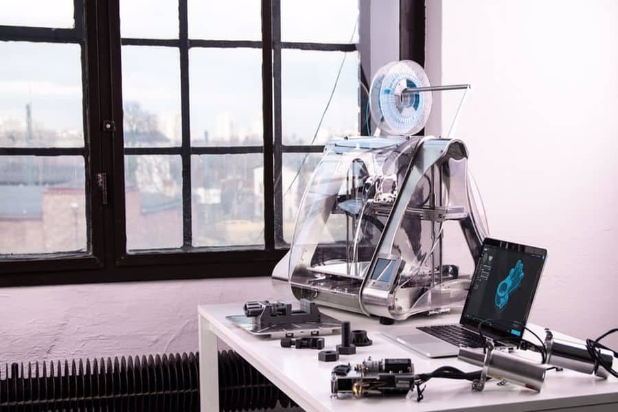 3D printer beside a laptop