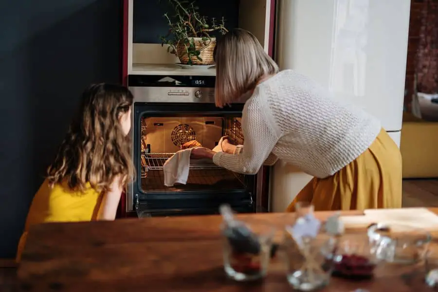 Mother and child using a clean oven
