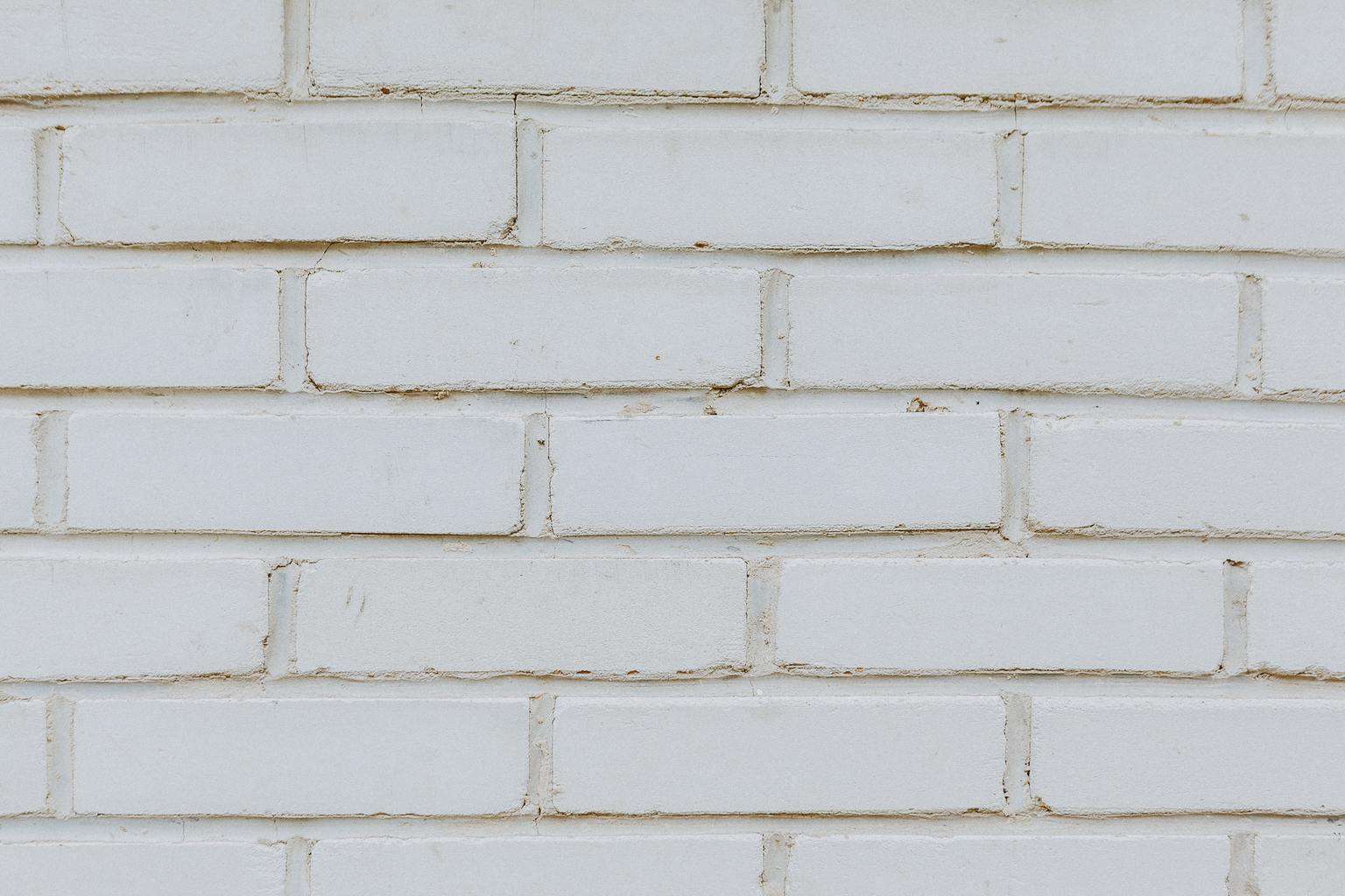 A white painted brick wall with stains