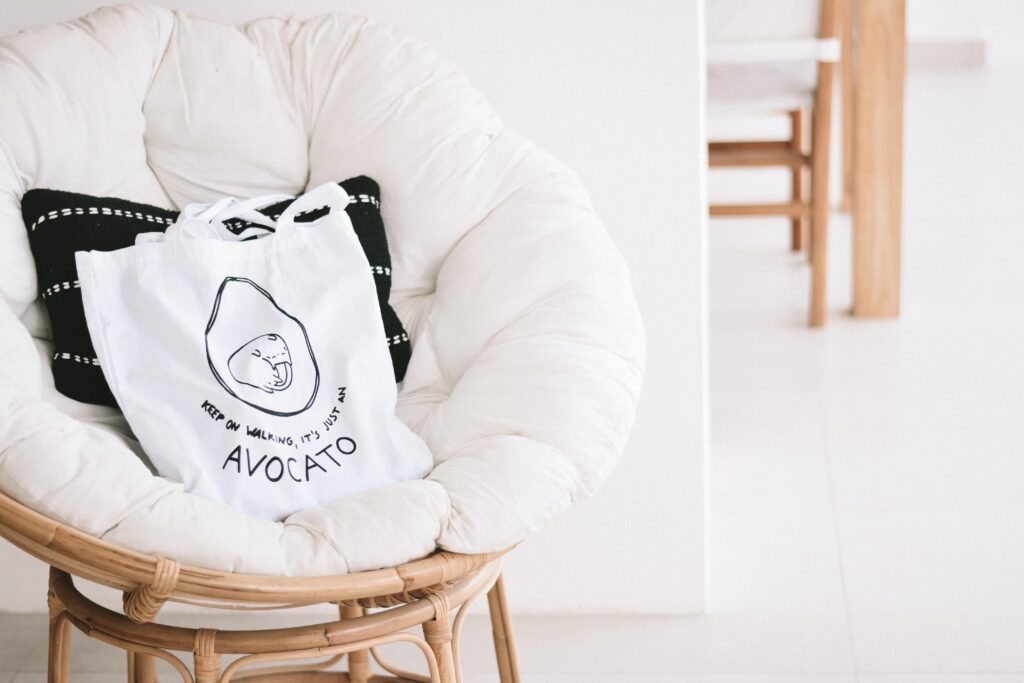 A bamboo papasan chair with a white papasan cushion