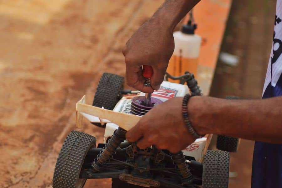 Person tinkering with an RC Car