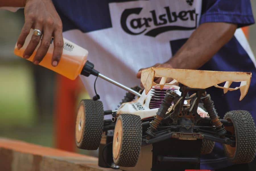 Man putting oil on an RC Car