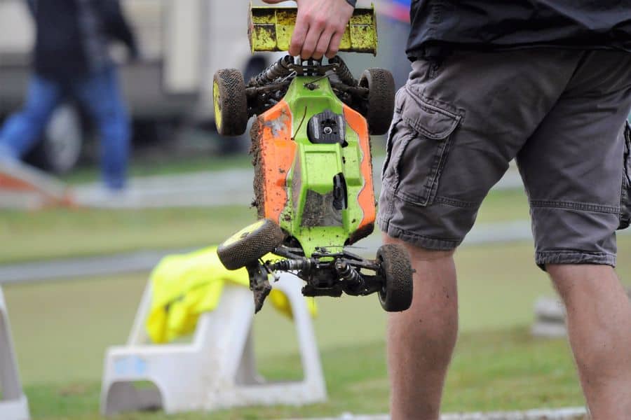 Man holding a dirty RC Car