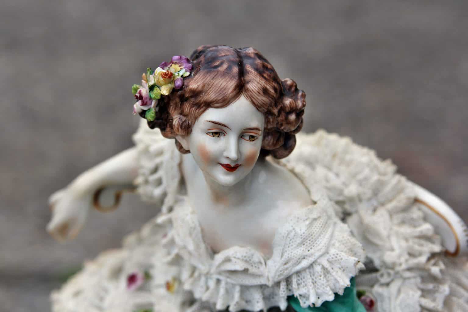 A porcelain figurine of a woman in a white dress