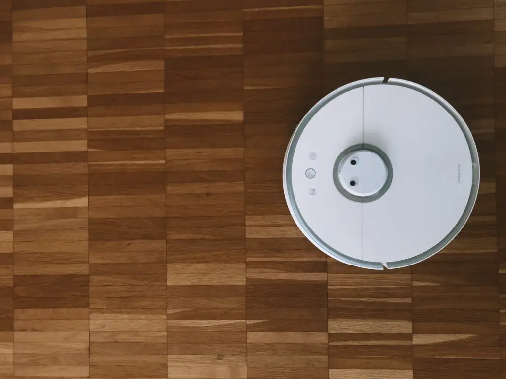 A robot vacuum on a hardwood floor