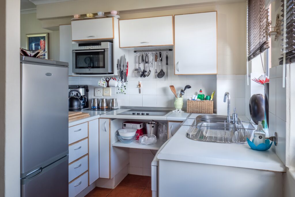 A kitchen area with a slate designed refrigerator