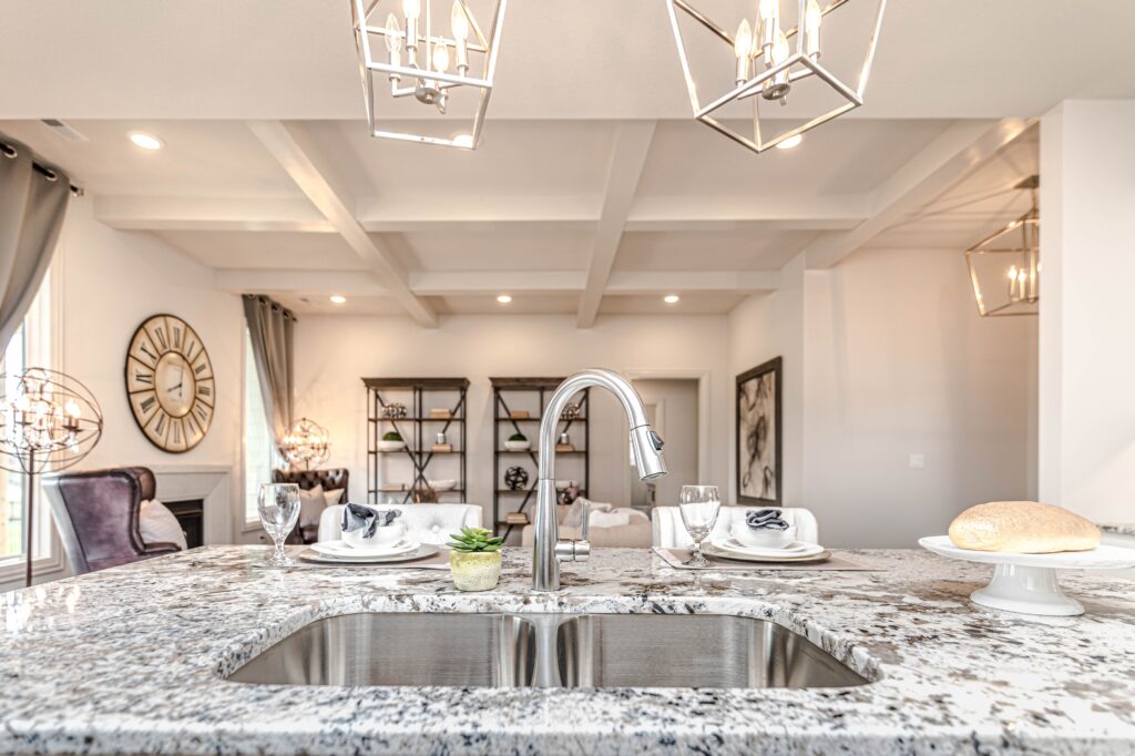 A marble kitchen countertop with plates and a sink