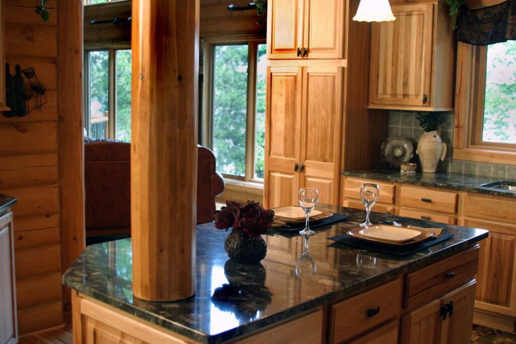 A marble countertop with wooden cabinets and a column