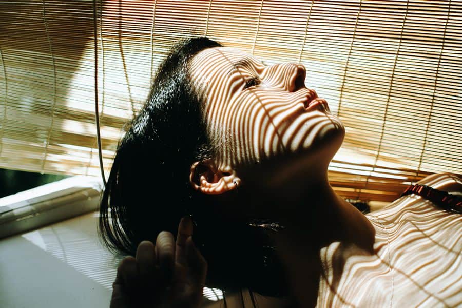 Woman lounging and enjoying her newly cleaned bamboo blinds