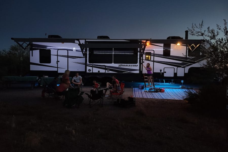 People sitting on a chair outside the RV