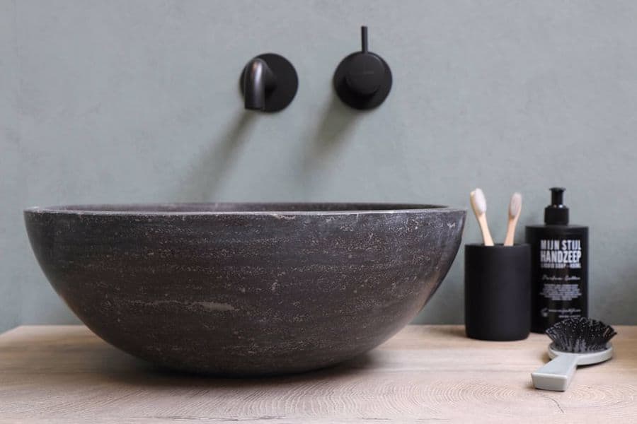 Wash basin with a hairbrush and a pair of toothbrush beside it