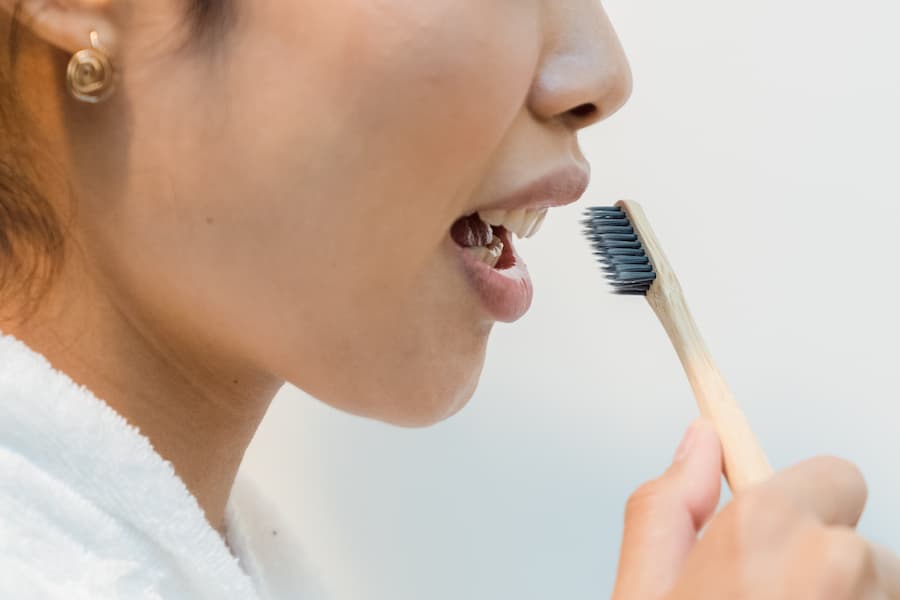 Woman brushing her gold teeth