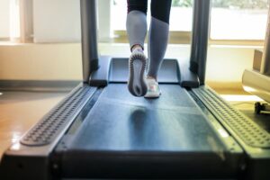 Woman running on treadmill belt