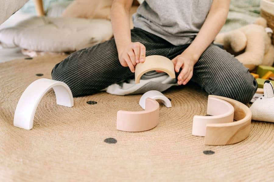 Curvy wooden toys playing by a kid