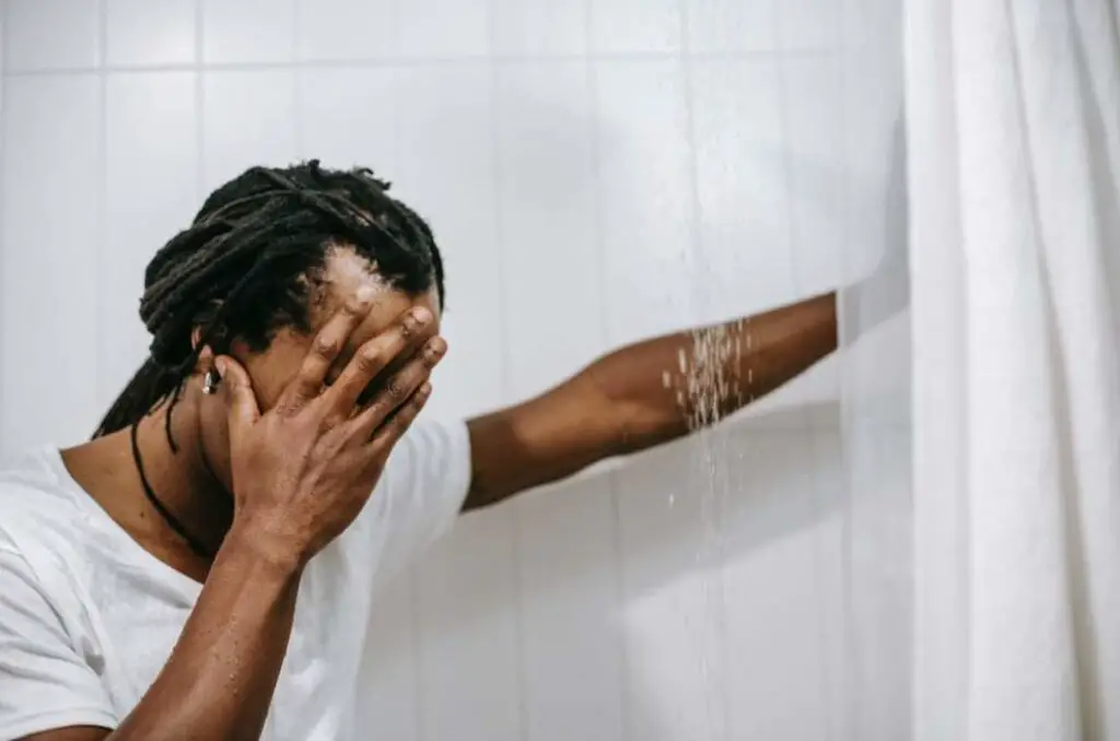 Man washing his dreadlocks in the shower