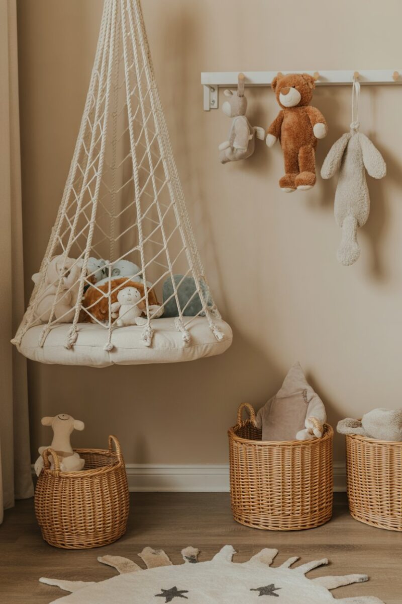 A room with a net hanging stuffed animals and baskets for storage.