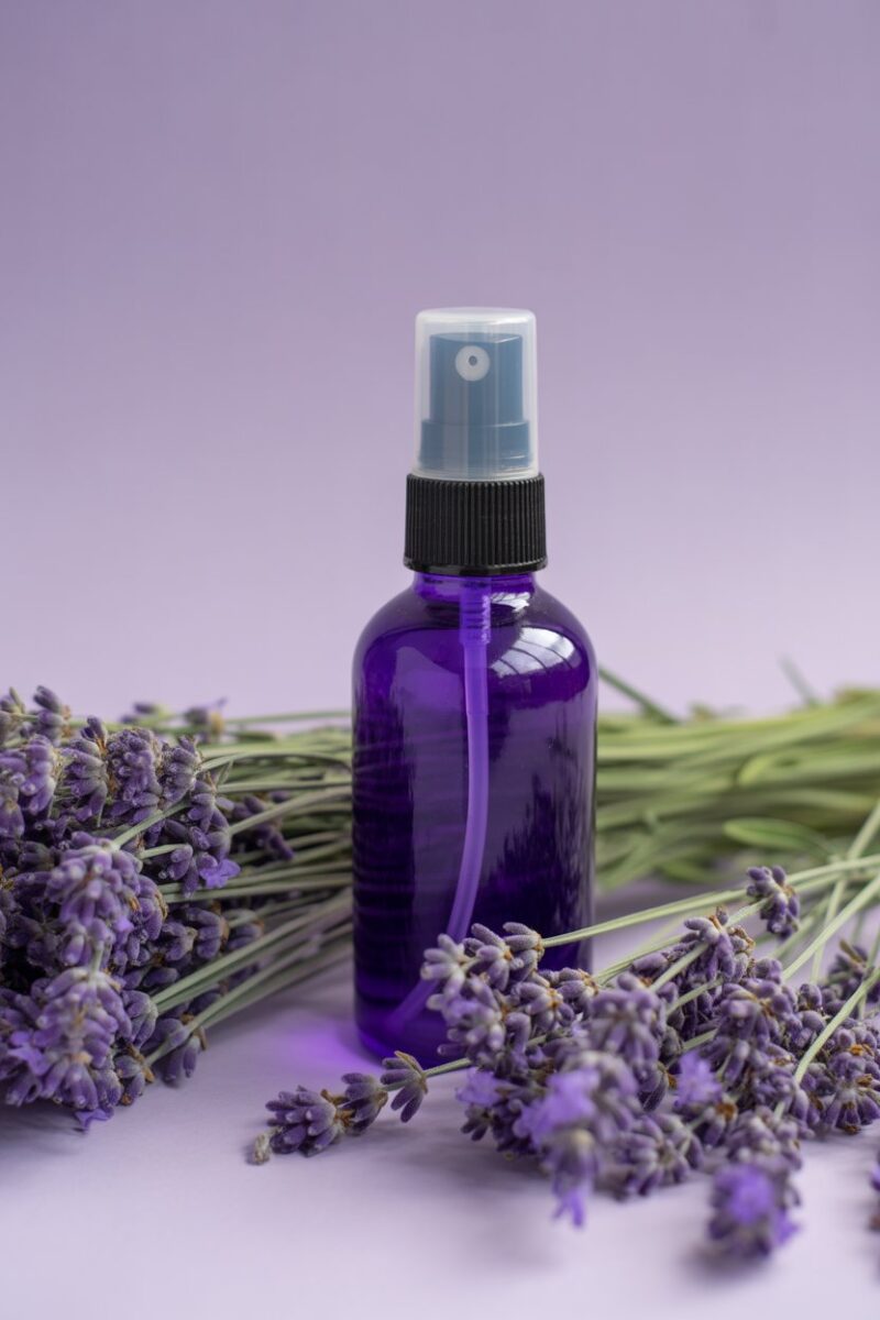 Lavender all-purpose spray bottle surrounded by lavender flowers.