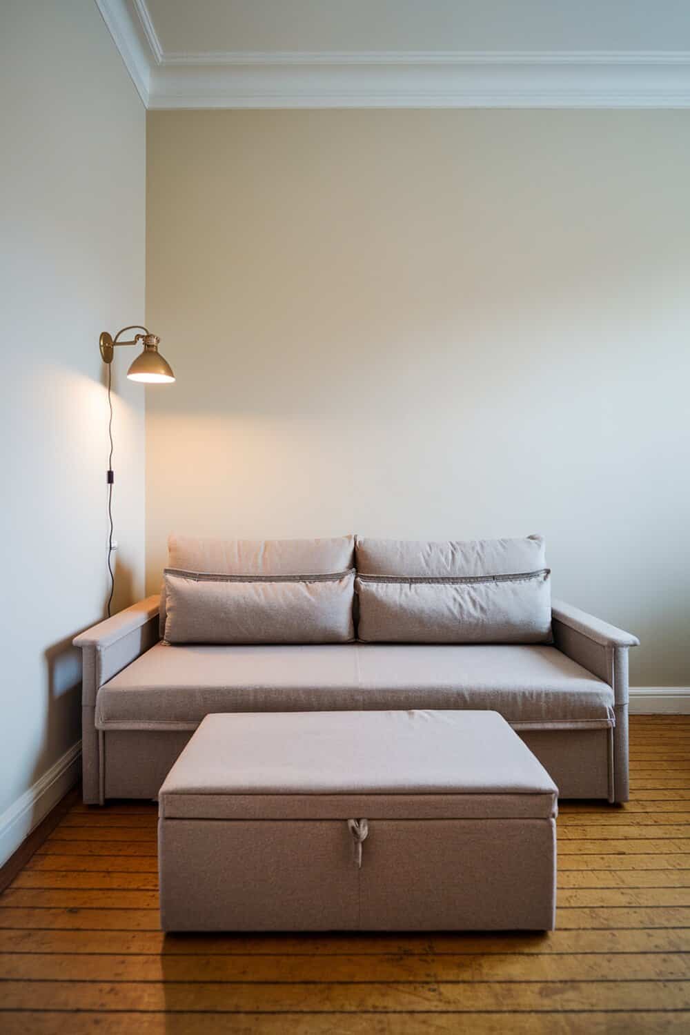 A cozy living room featuring a sofa and a storage coffee table.