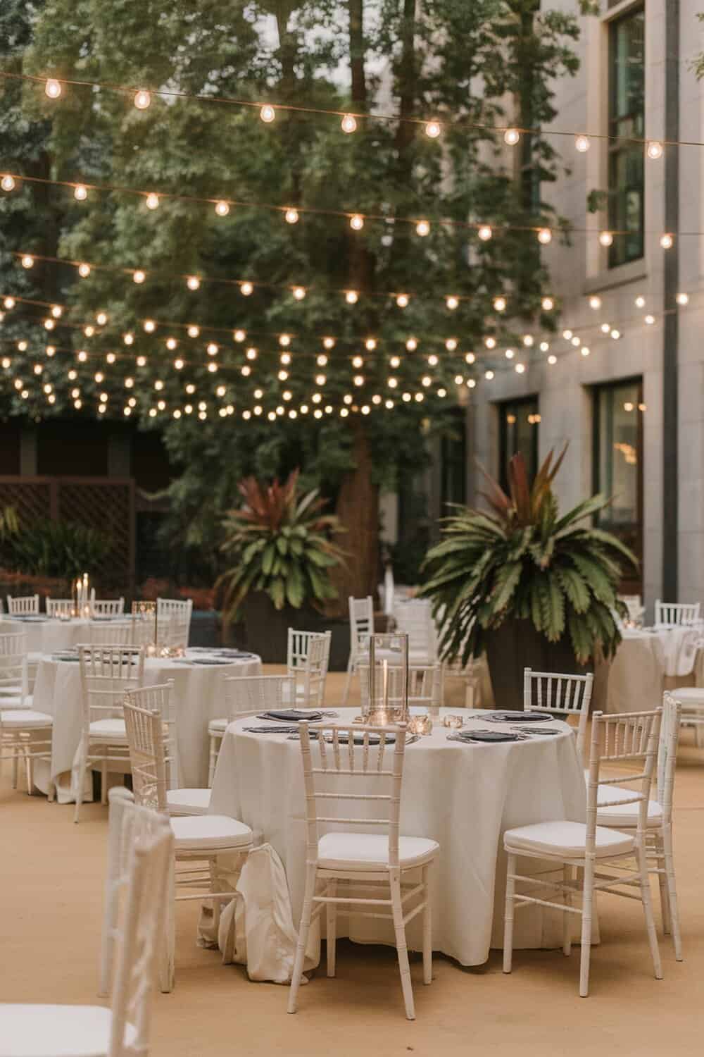 Outdoor space decorated with string lights overhead.