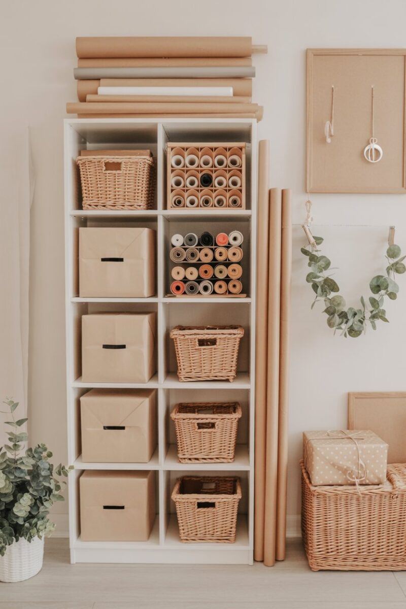 A neatly organized wrapping paper storage with rolls and ribbons.