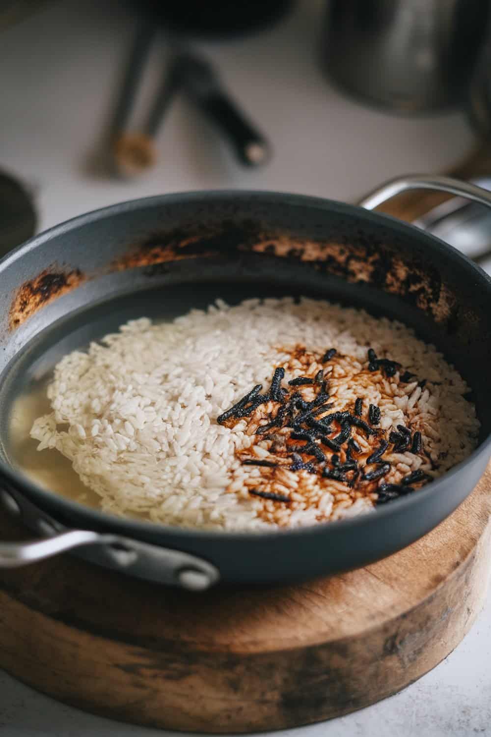 A burnt pan with rice and water soaking inside.