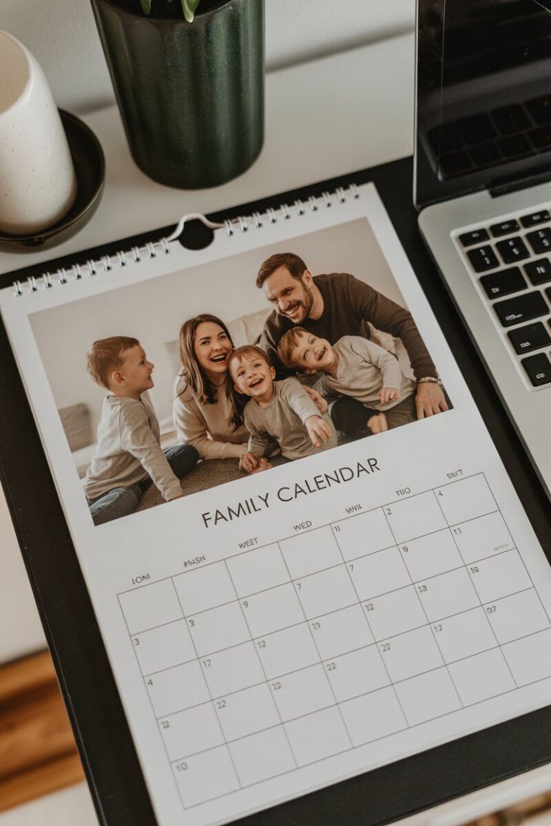 A personalized photo calendar displayed on a table with festive decorations.