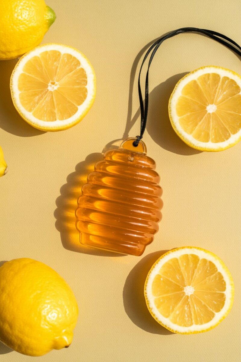 A vibrant honey and citrus air freshener with lemon slices and honeycomb design.