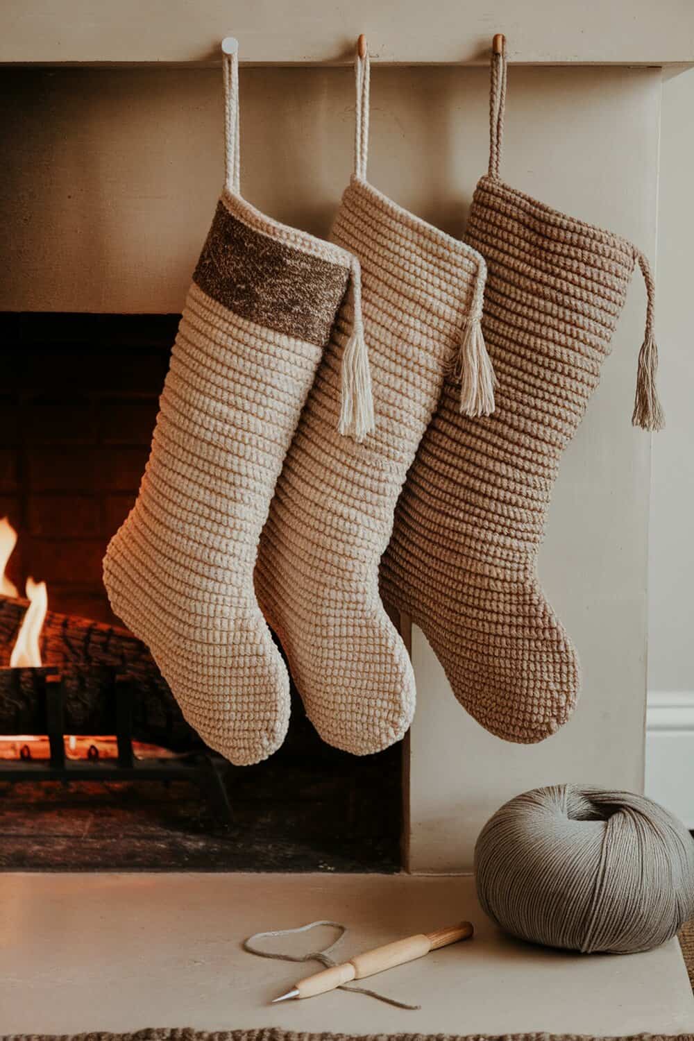 Three natural fiber stockings hanging by a fireplace