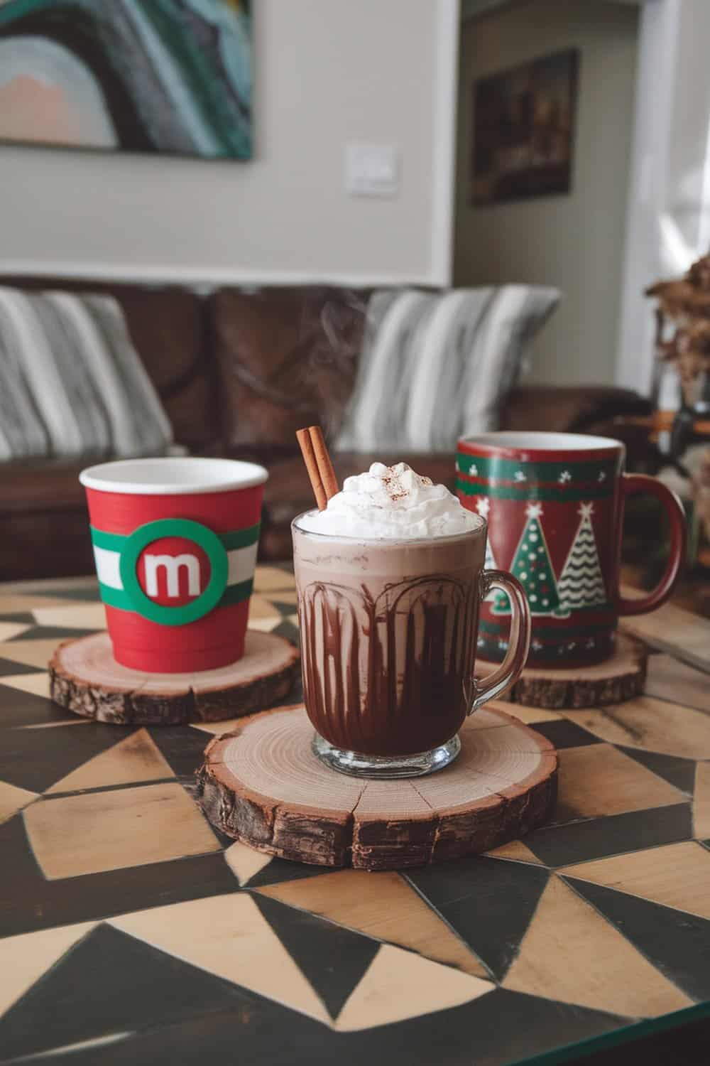 Wood slice coasters with hot chocolate and festive cups on a patterned table.
