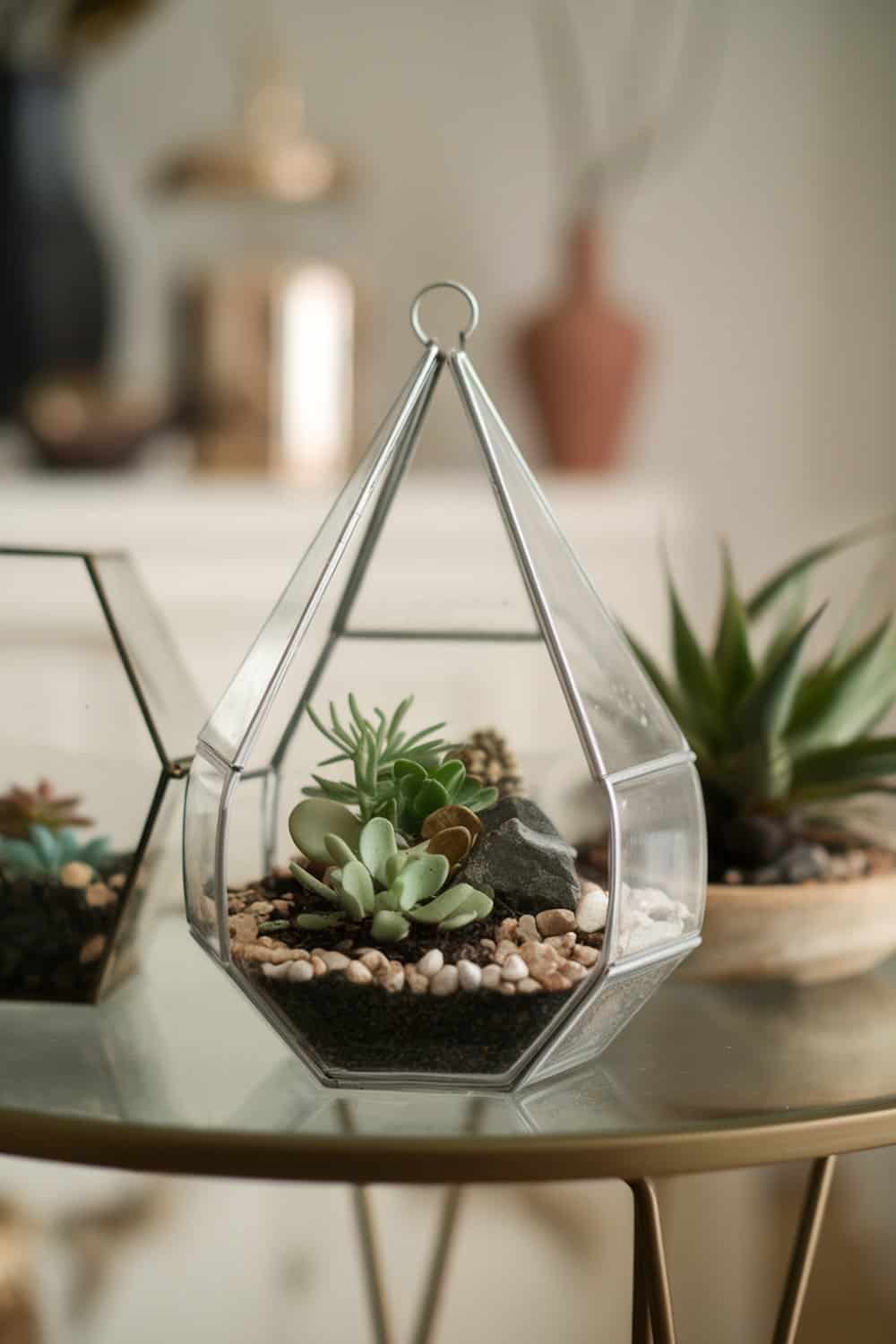 A beautiful terrarium featuring succulents and decorative stones in a glass container.