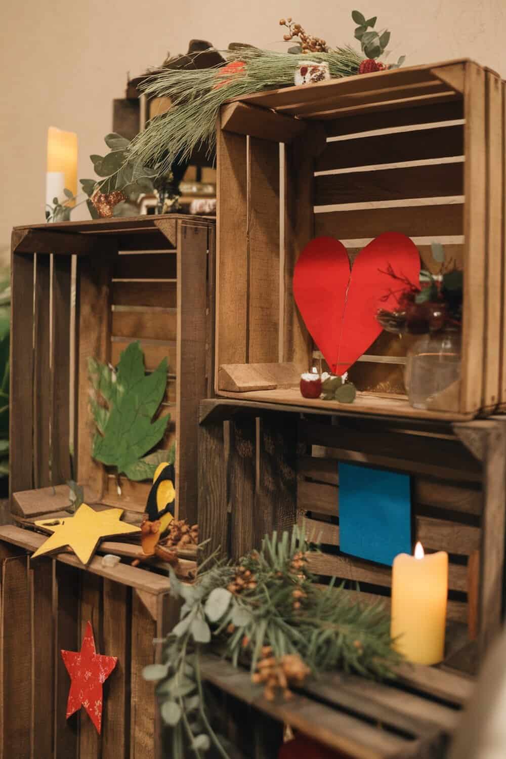 Decorative wooden crates filled with holiday items and greenery.
