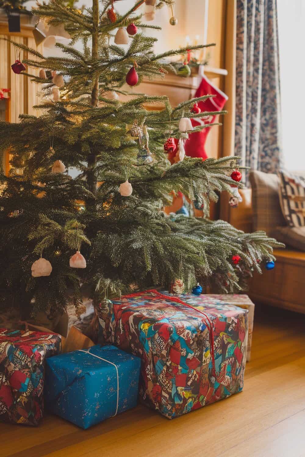 Colorful fabric scrap gift wrap under a Christmas tree.
