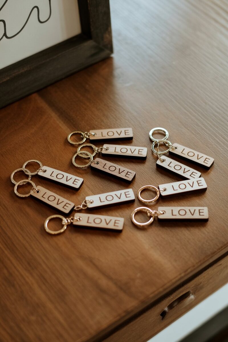 A collection of personalized wooden keychains on a wooden table.