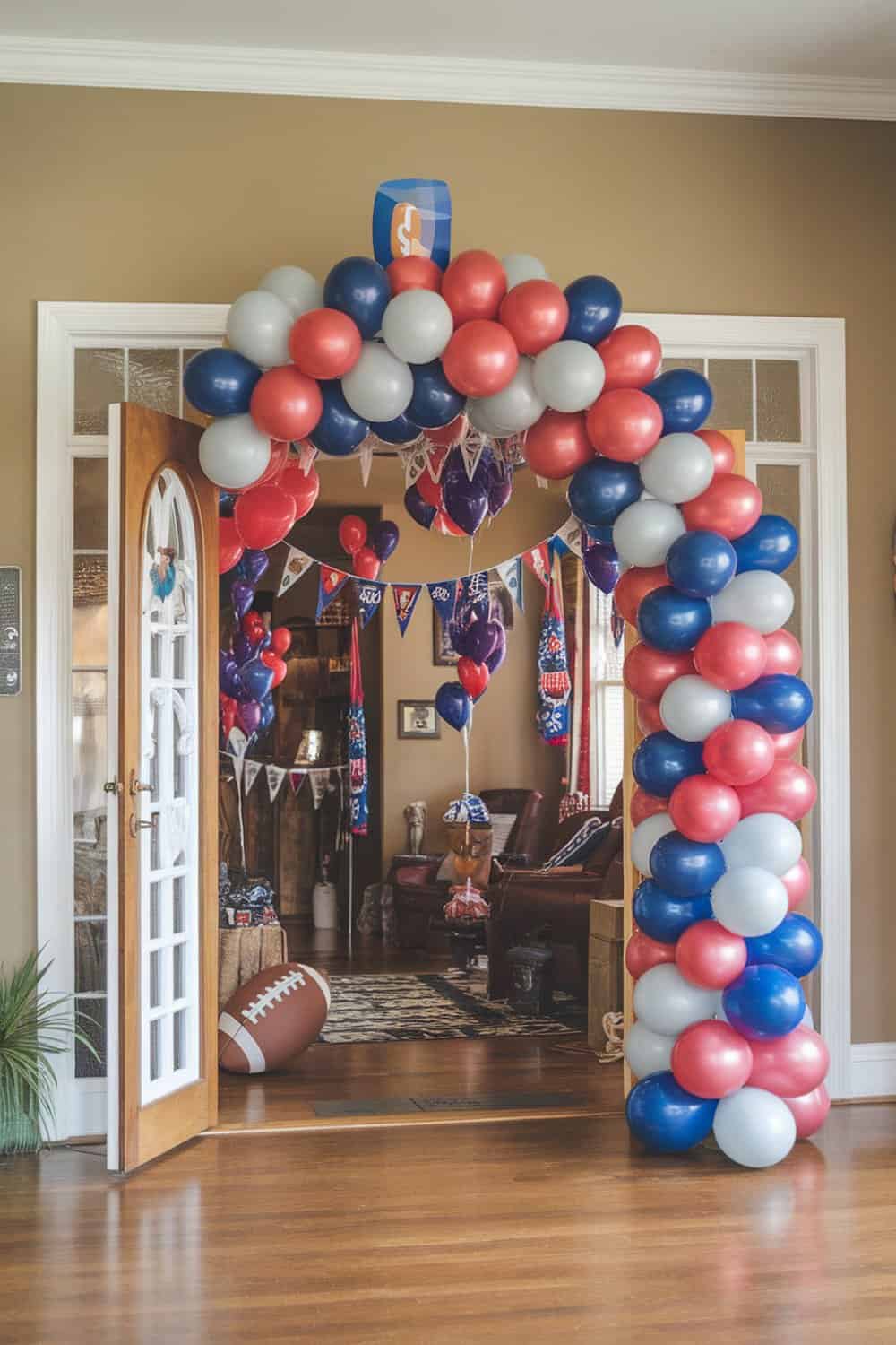 A colorful balloon arch in team colors at the entrance of a football party.