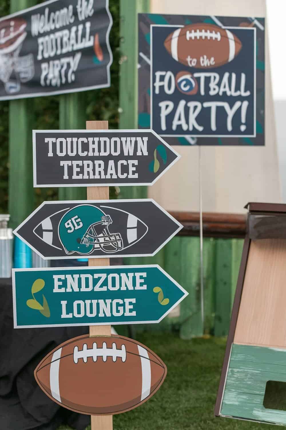 Football party signage with directional signs for Touchdown Terrace and Endzone Lounge.