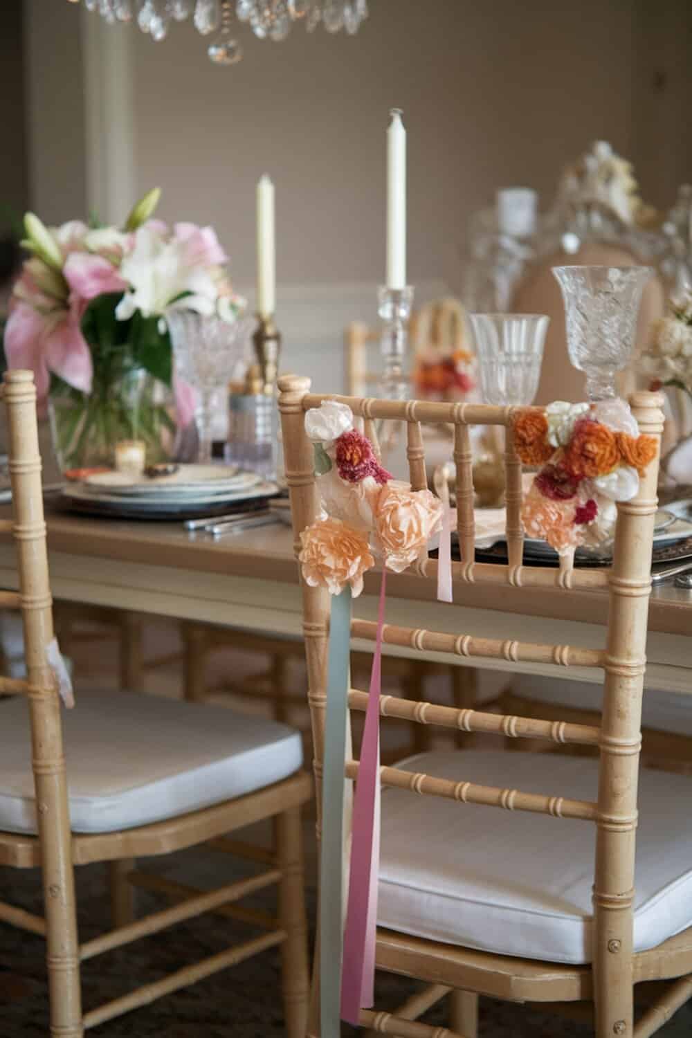 Decorated chairs with flowers and ribbons for Valentine's table setting.