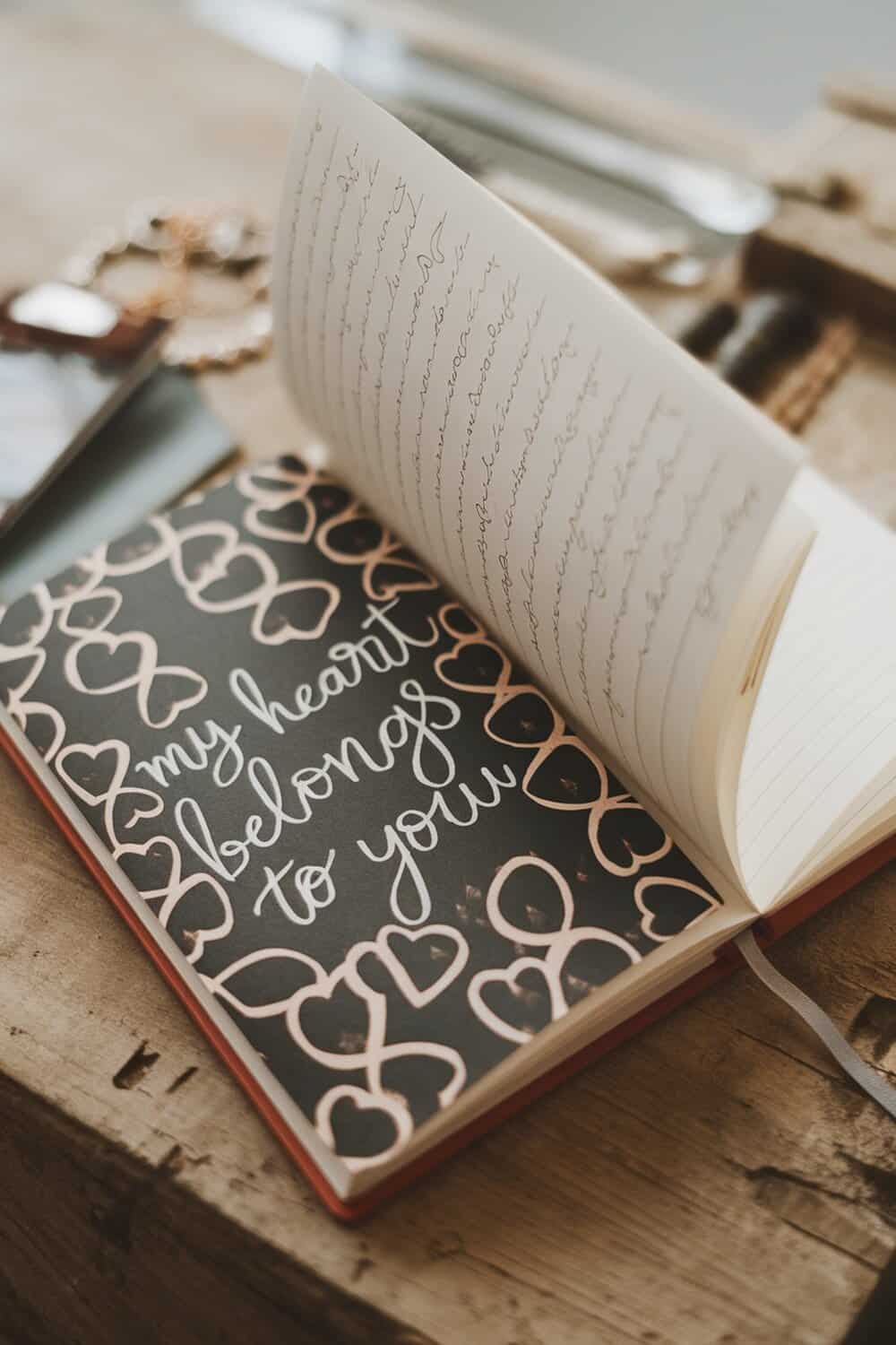 A customized notebook with a heart design and handwritten notes inside.