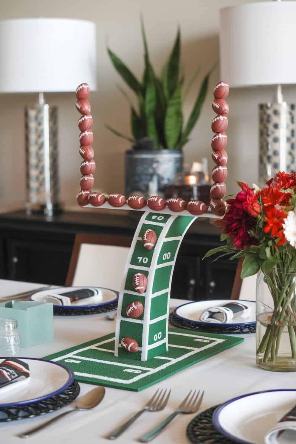 A creative goal post centerpiece made with mini footballs and a green field design.