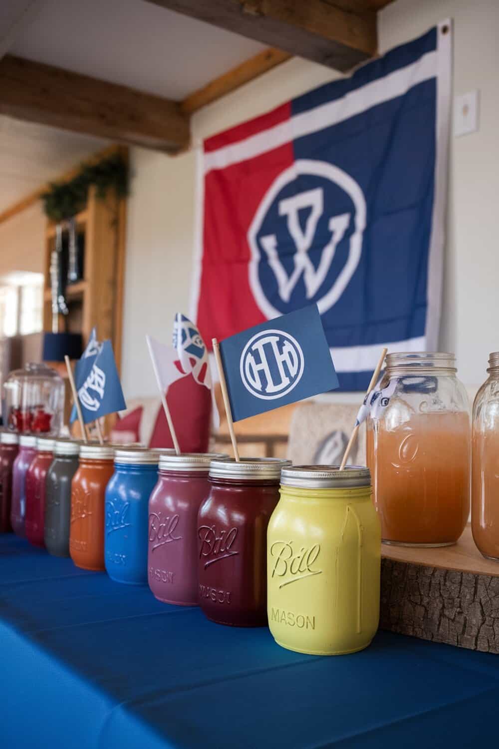 Colorful painted mason jars lined up on a table for drinks at a football party.