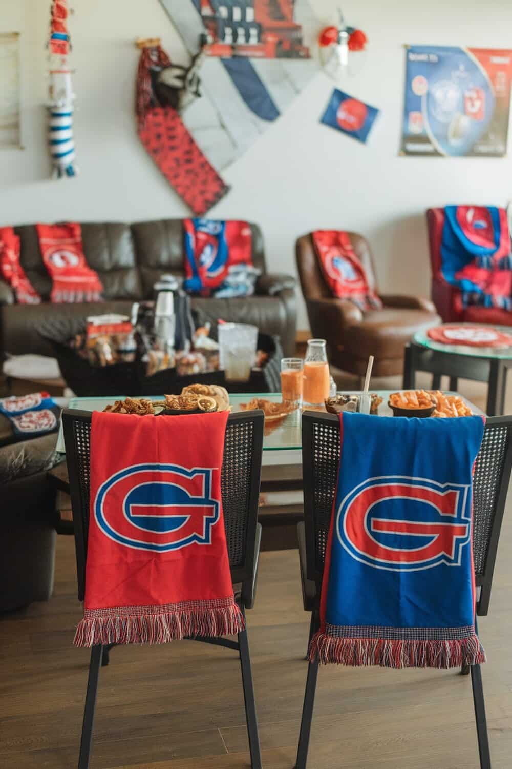 Two chairs with team color scarves draped over them, showcasing a festive Super Bowl party setup.